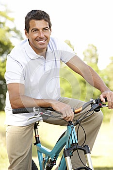 Young man riding bike in countryside