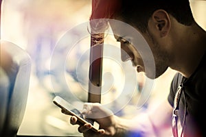 Young man riding bus or pullman texting photo