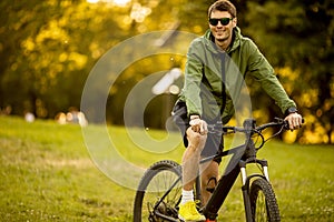 Young man riding ebike in the park