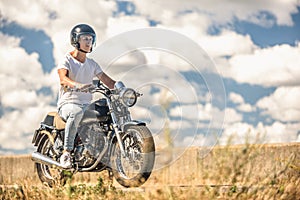 Young man riding his motorbike on open road