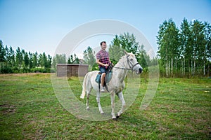 Young man riding a horse