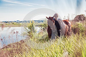 Young man riding a horse in the field