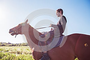 Young man riding a horse in the field