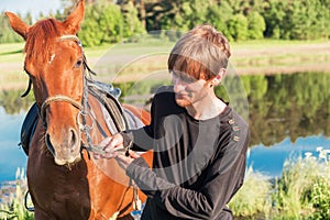 Young man riding a horse in the field