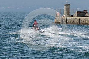 Young man riding a jet ski in the sea