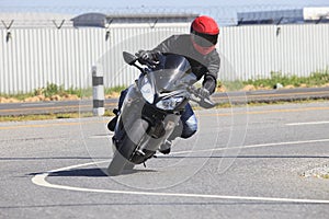 Young man riding motorcycle in asphalt road curve use for male a