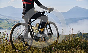 Young man riding a mountain bike downhill style