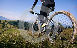 Young man riding a mountain bike downhill style