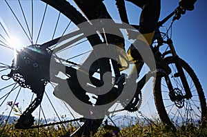 Young man riding a mountain bike downhill style