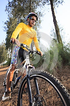 Young man riding mountain bike mtb in jungle track use for sport