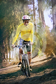 Young man riding mountain bike mtb in jungle track use for sport