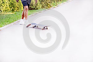 Young man riding a skateboard left direction of movement close-up
