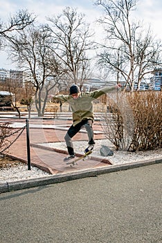 Young man riding a skateboard making tricks and jumps