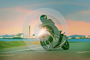 Young man riding sport touring motorcycle on asphalt highways ag