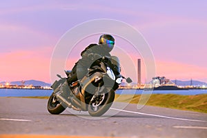 Young man riding sport touring motorcycle on asphalt highways ag
