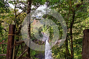 A young man riding on a zip line rope in an extreme adventure jungle in Xico, Veracruz, Mexico