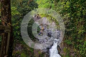 A young man riding on a zip line rope in an extreme adventure jungle in Xico, Veracruz, Mexico