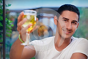 Young Man Rising a Glass in a Bar