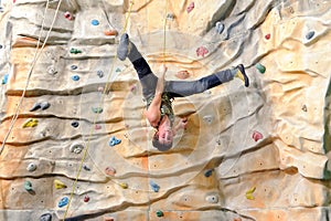 Young man on rock wall