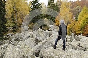 Young man on a rocks in the mountain.