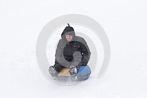 Young man with roller coaster rides in the winter