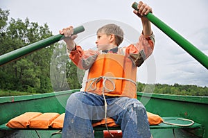 Young man rowing a boat