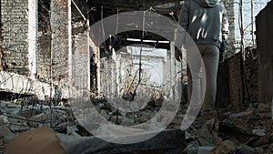 A young man in a ruined house, a lonely and sad guy examines an abandoned room.