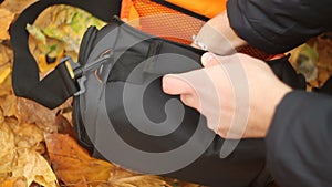 A young man rummages in a bag