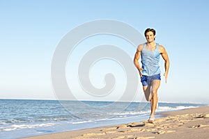 Young Man Running Along Beach