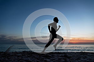 Young man running on the beach