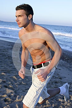 Young man running on the blue beach