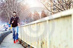 A young man running on the bridge