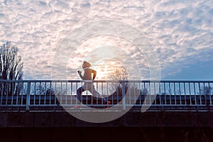 A young man running on the bridge