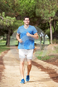 Young man running in park