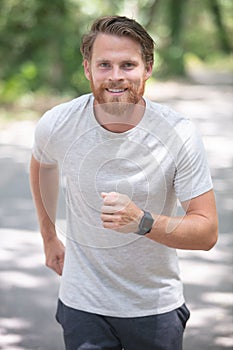 Young man running on road