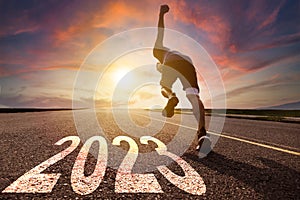 Young man running and sprinting on the road with new year 2023 concept