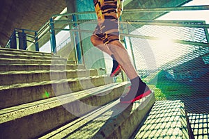 Young man running up the stairs outdoor in the city