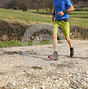 young man runs during cross country race