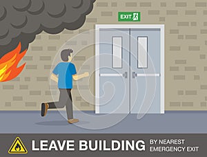 Young man runs from the fire to the exit doors. Leave the building by nearest emergency exit.