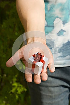 Young man's hand with gift