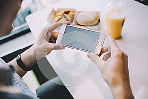 Young man`s hand holding mobile phone