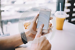 Young man`s hand holding mobile phone