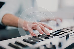 Young man`s hands playing keyboard piano, composing music , music record concep, art, song composition, melody