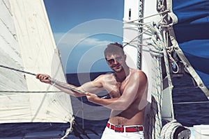 Young man sailing his boat on the open ocean