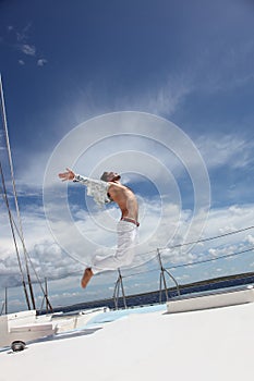 Young man sailing his boat on the open ocean