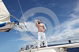 Young man sailing his boat on the open ocean