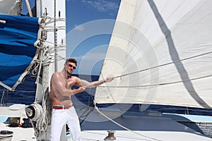 Young man sailing his boat on the open ocean