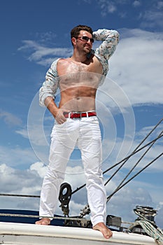 Young man sailing his boat on the open ocean