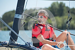 Young man sailing on hobie cat