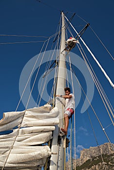 Young man on sailing ship, active lifestyle, summer sport concept